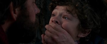 Movie still from “A Quiet Place” (2018), directed by John Krasinski – A man and a child with their hands over their mouths; Close Up shot, Low angle