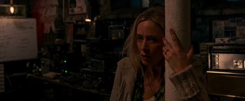 Movie still from “A Quiet Place” (2018), directed by John Krasinski – A woman leaning against a wall in a dark room; Close Up shot, High angle