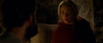 Movie still from “A Quiet Place” (2018), directed by John Krasinski – A woman sitting on a couch looking at a man; Close Up shot, Over the shoulder angle