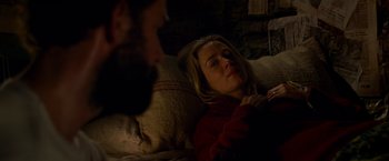 Movie still from “A Quiet Place” (2018), directed by John Krasinski – A man and a woman laying on a couch; Close Up shot, High angle