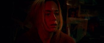 Movie still from “A Quiet Place” (2018), directed by John Krasinski – A woman with blonde hair and a brown jacket looking sad; Close Up shot, High angle