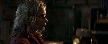 Movie still from “A Quiet Place” (2018), directed by John Krasinski – A woman with blonde hair is looking to her left; Close Up shot, Over the shoulder angle