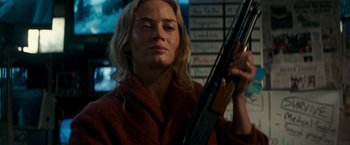 Movie still from “A Quiet Place” (2018), directed by John Krasinski – A woman is holding a violin in front of a wall; Close Up shot, Low angle