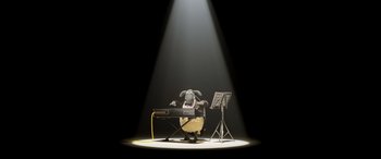 Movie still from “A Shaun the Sheep Movie: Farmageddon” (2019), directed by Will Becher – A chair and a keyboard on a stage with a spotlight; Extreme Wide shot, High angle
