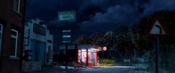 Movie still from “A Shaun the Sheep Movie: Farmageddon” (2019), directed by Will Becher – A night time scene of an auto repair shop; Extreme Wide shot, High angle