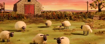 Movie still from “A Shaun the Sheep Movie: Farmageddon” (2019), directed by Will Becher – A group of sheep standing in the grass; Extreme Wide shot, High angle