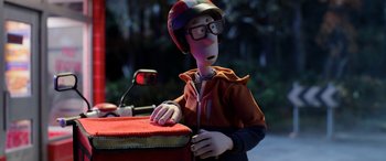 Movie still from “A Shaun the Sheep Movie: Farmageddon” (2019), directed by Will Becher – A person wearing a helmet and riding a motorcycle; Medium shot, Over the shoulder angle