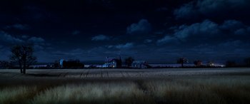 Movie still from “A Shaun the Sheep Movie: Farmageddon” (2019), directed by Will Becher – A field with a house in the background at night; Extreme Wide shot, High angle