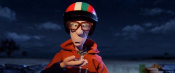 Movie still from “A Shaun the Sheep Movie: Farmageddon” (2019), directed by Will Becher – A man wearing a helmet and glasses holding a bird; Close Up shot, High angle