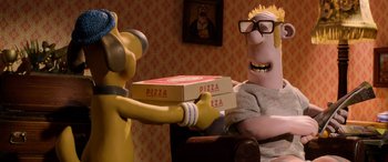 Movie still from “A Shaun the Sheep Movie: Farmageddon” (2019), directed by Will Becher – A person holding a pizza box while another person sits in a chair; Medium shot, Over the shoulder angle
