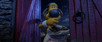 Movie still from “A Shaun the Sheep Movie: Farmageddon” (2019), directed by Will Becher – A dog is standing next to a bag of dog food; Close Up shot, High angle
