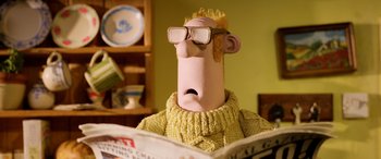 Movie still from “A Shaun the Sheep Movie: Farmageddon” (2019), directed by Will Becher – A cartoon character reading a book; Close Up shot, Over the shoulder angle