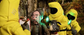 Movie still from “A Shaun the Sheep Movie: Farmageddon” (2019), directed by Will Becher – A group of people dressed up as characters from a movie; Medium shot, Over the shoulder angle