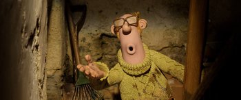 Movie still from “A Shaun the Sheep Movie: Farmageddon” (2019), directed by Will Becher – A man in a yellow sweater holding a fork; Close Up shot, High angle