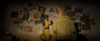 Movie still from “A Shaun the Sheep Movie: Farmageddon” (2019), directed by Will Becher – A dog and a man are looking at each other in front of a wall covered with papers; Medium shot, High angle
