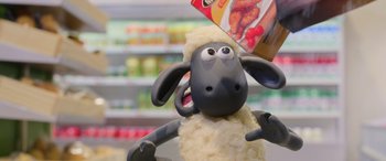 Movie still from “A Shaun the Sheep Movie: Farmageddon” (2019), directed by Will Becher – A toy sheep is standing in front of some food; Close Up shot, Low angle