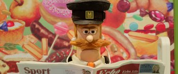 Movie still from “A Shaun the Sheep Movie: Farmageddon” (2019), directed by Will Becher – A pastry with a beard and a hat; Extreme Close Up shot, Low angle