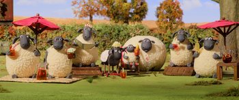 Movie still from “A Shaun the Sheep Movie: Farmageddon” (2019), directed by Will Becher – A group of sheep statues sitting on top of a grass covered field; Extreme Wide shot, High angle