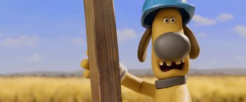 Movie still from “A Shaun the Sheep Movie: Farmageddon” (2019), directed by Will Becher – A dog holding a wooden pole in a field; Close Up shot, Low angle