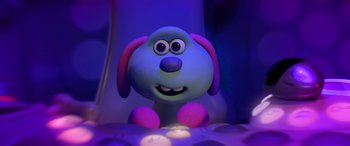 Movie still from “A Shaun the Sheep Movie: Farmageddon” (2019), directed by Will Becher – A toy dog is sitting in the dark; Close Up shot, High angle