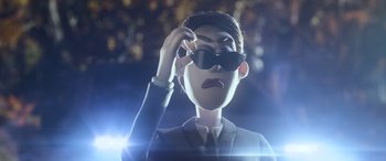 Movie still from “A Shaun the Sheep Movie: Farmageddon” (2019), directed by Will Becher – A man in a suit and tie holding a pair of sunglasses; Close Up shot, Low angle