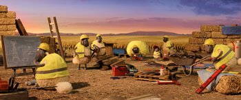 Movie still from “A Shaun the Sheep Movie: Farmageddon” (2019), directed by Will Becher – A group of people dressed as sheep in the middle of a field; Wide shot, High angle