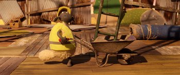 Movie still from “A Shaun the Sheep Movie: Farmageddon” (2019), directed by Will Becher – A toy sheep with a yellow shirt and a yellow hat; Wide shot, High angle