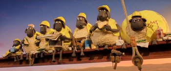 Movie still from “A Shaun the Sheep Movie: Farmageddon” (2019), directed by Will Becher – A group of sheep sitting next to each other on top of a train; Wide shot, Low angle