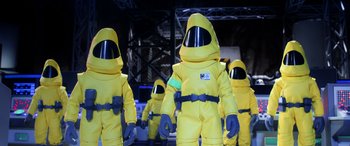 Movie still from “A Shaun the Sheep Movie: Farmageddon” (2019), directed by Will Becher – A group of people dressed in yellow suits; Medium shot, Low angle