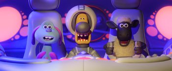 Movie still from “A Shaun the Sheep Movie: Farmageddon” (2019), directed by Will Becher – A group of cartoon characters sitting in front of each other; Wide shot, Low angle