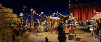 Movie still from “A Shaun the Sheep Movie: Farmageddon” (2019), directed by Will Becher – A group of people standing in a field at night; Extreme Wide shot, High angle