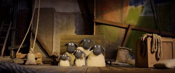 Movie still from “A Shaun the Sheep Movie: Farmageddon” (2019), directed by Will Becher – A group of sheep sitting on top of a wooden table; Wide shot, High angle