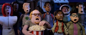 Movie still from “A Shaun the Sheep Movie: Farmageddon” (2019), directed by Will Becher – A group of people that are standing around a bowl of popcorn; Medium shot, Low angle