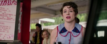 Movie still from “The Founder” (2016), directed by John Lee Hancock – A woman standing in front of a group of other people; Close Up shot, Over the shoulder angle