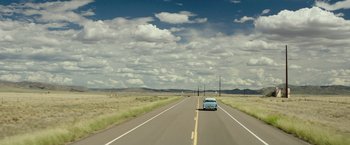 Movie still from “The Founder” (2016), directed by John Lee Hancock – A car driving down the middle of a road; Extreme Wide shot, High angle