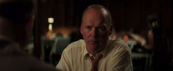 Movie still from “The Founder” (2016), directed by John Lee Hancock – An older man wearing a yellow tie and a white shirt; Close Up shot, Over the shoulder angle