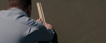 Movie still from “The Founder” (2016), directed by John Lee Hancock – A person holding a ruler and a ruler in their hand; Extreme Close Up shot, High angle