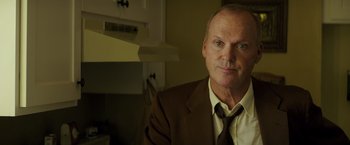 Movie still from “The Founder” (2016), directed by John Lee Hancock – A person wearing a suit and tie; Close Up shot, Low angle