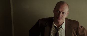 Movie still from “The Founder” (2016), directed by John Lee Hancock – A person wearing a suit and tie; Close Up shot, Low angle