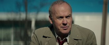 Movie still from “The Founder” (2016), directed by John Lee Hancock – An older man wearing a suit and tie; Close Up shot, Over the shoulder angle