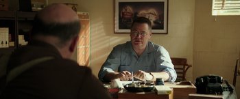Movie still from “The Founder” (2016), directed by John Lee Hancock – A man sitting in front of another man at a table; Medium shot, Over the shoulder angle