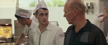 Movie still from “The Founder” (2016), directed by John Lee Hancock – A man wearing a paper hat talking to another man; Close Up shot, Over the shoulder angle