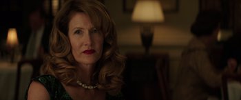 Movie still from “The Founder” (2016), directed by John Lee Hancock – A person wearing a necklace; Close Up shot, Over the shoulder angle