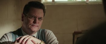 Movie still from “The Founder” (2016), directed by John Lee Hancock – A person wearing glasses; Close Up shot, Over the shoulder angle