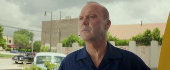 Movie still from “The Founder” (2016), directed by John Lee Hancock – A man in a blue shirt looking up at the sky; Close Up shot, Low angle