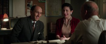 Movie still from “The Founder” (2016), directed by John Lee Hancock – A man and a woman sitting at a table smiling; Medium shot, Over the shoulder angle