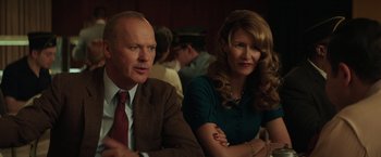 Movie still from “The Founder” (2016), directed by John Lee Hancock – A man and a woman sitting next to each other in a room; Close Up shot, Over the shoulder angle