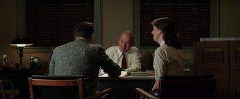 Movie still from “The Founder” (2016), directed by John Lee Hancock – A man and two women sitting at a table; Medium shot, Over the shoulder angle