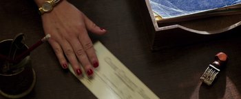 Movie still from “The Founder” (2016), directed by John Lee Hancock – A woman with red nail polish is holding a piece of paper; Extreme Close Up shot, Overhead angle