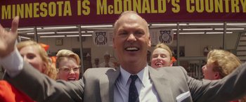 Movie still from “The Founder” (2016), directed by John Lee Hancock – Two women and a man in a suit and tie; Close Up shot, Low angle